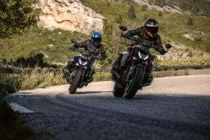 2026 BMW R 1300 R roadster riding through an urban street setting